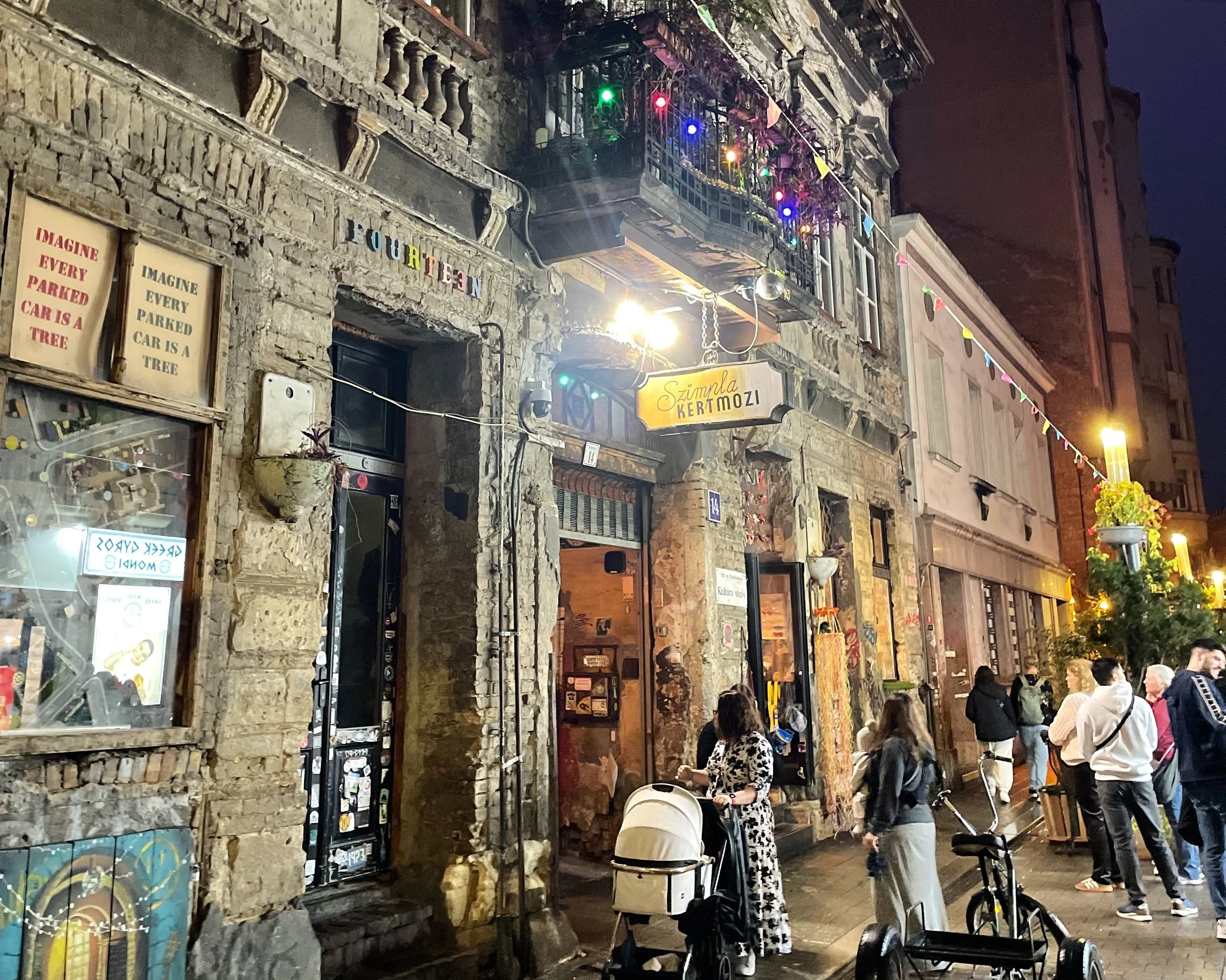 District VII street at night- cobblestones and the warm glow of ruin bar doorways on Kazinczy utca